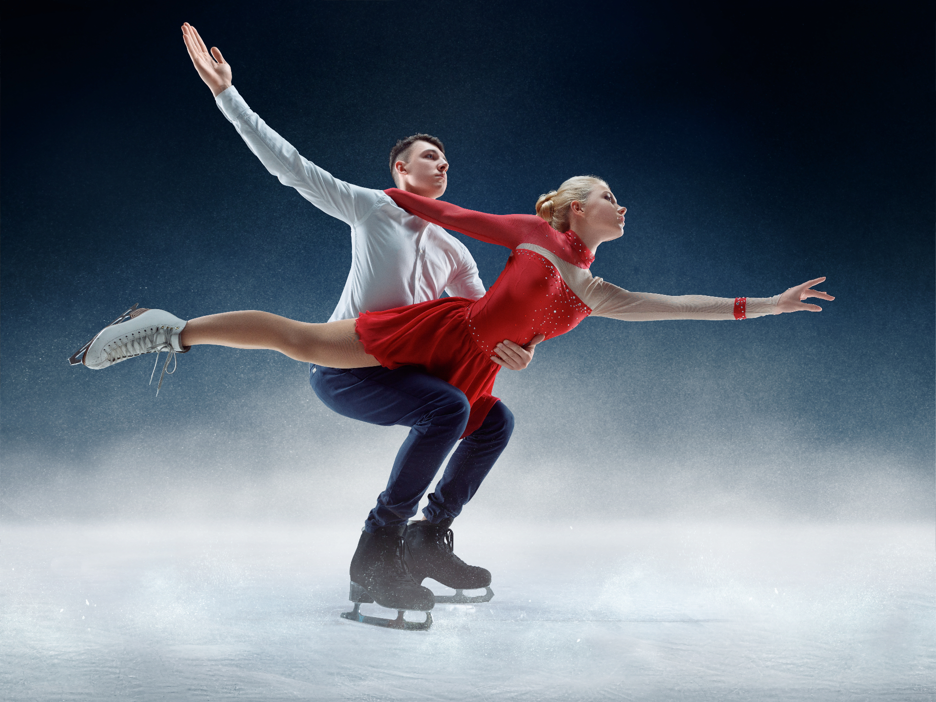 Figure skating pair performing a dramatic lift on ice